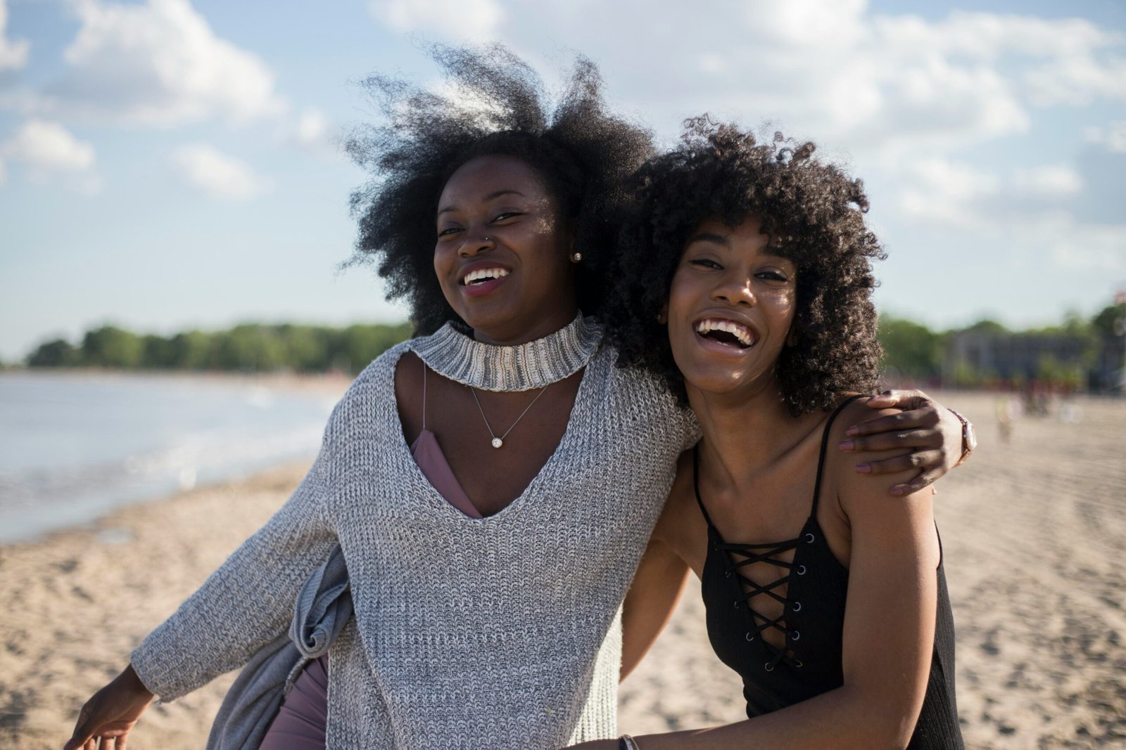 photo of woman beside another woman at seashore